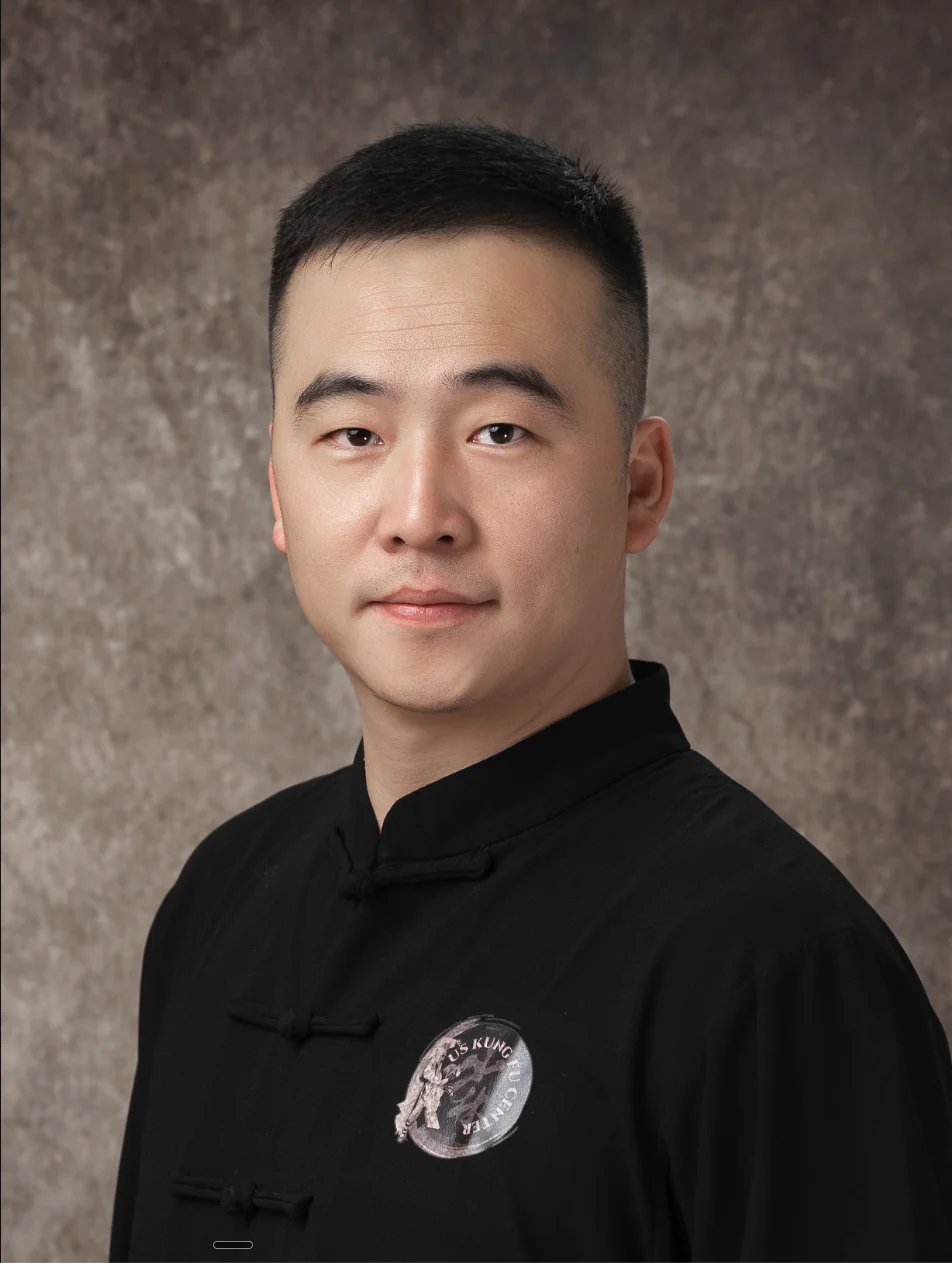 Yanguang Shifu, head instructor, in a black kung fu jacket