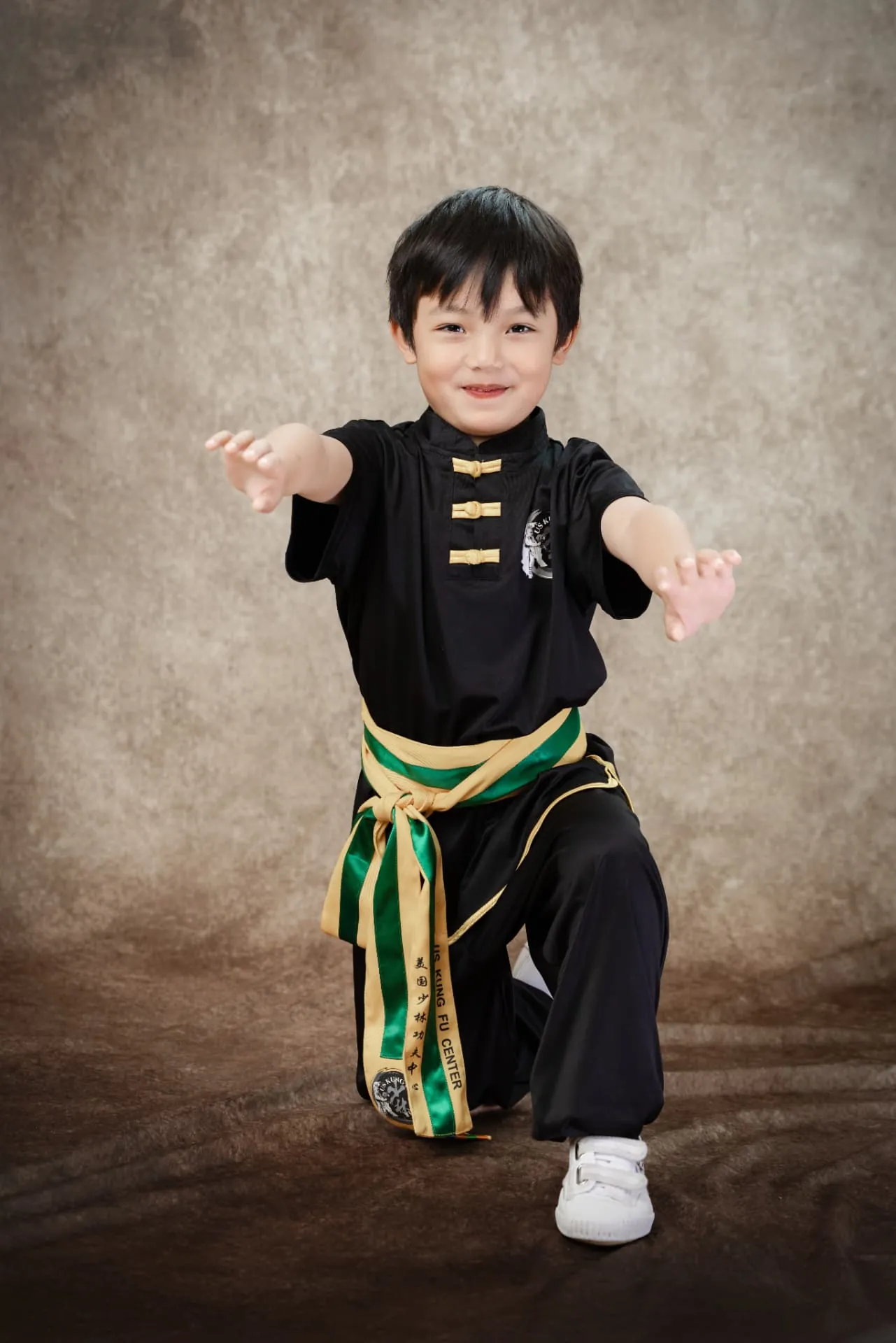 Young student in uniform in a crouching stance